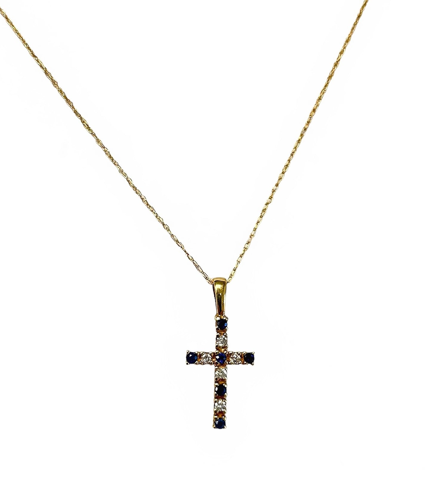 Yellow gold cross necklace with sapphires and diamonds.